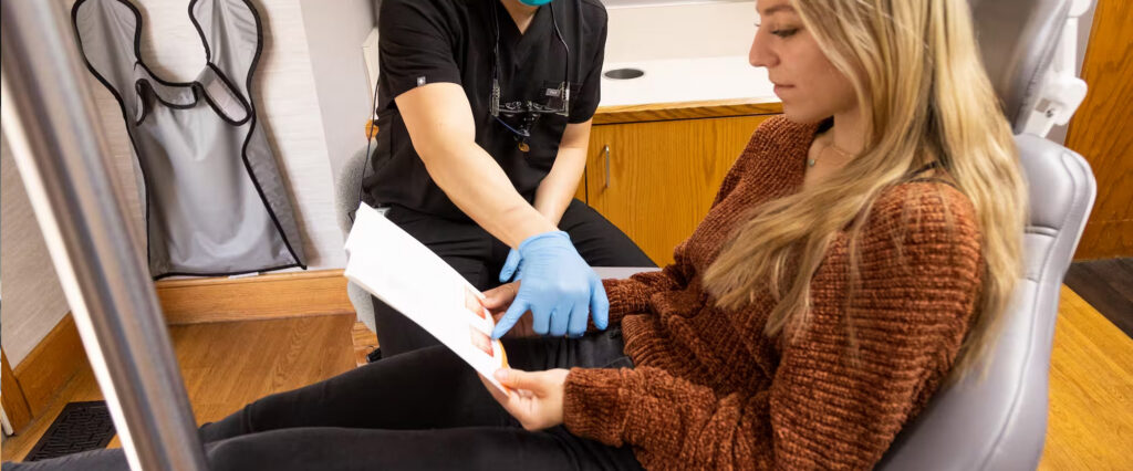 dentist at Aspenwood Dental Associates and Colorado Dental Implant Center talking to a patient