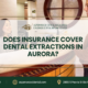 Aspenwood Dental Associates reception desk with a patient and staff member, featuring the text: “Does insurance cover dental extractions in Aurora?” plus the clinic’s phone number, website, and address.