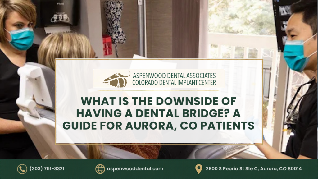 A dentist consults with a patient in an exam room, overlaid with the text: “Aspenwood Dental Associates: What is the downside of having a dental bridge? A guide for Aurora, CO patients.”